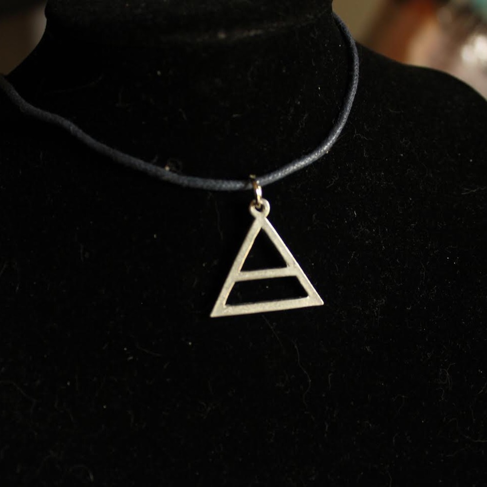 Silver pyramid shaped necklace on leather cord